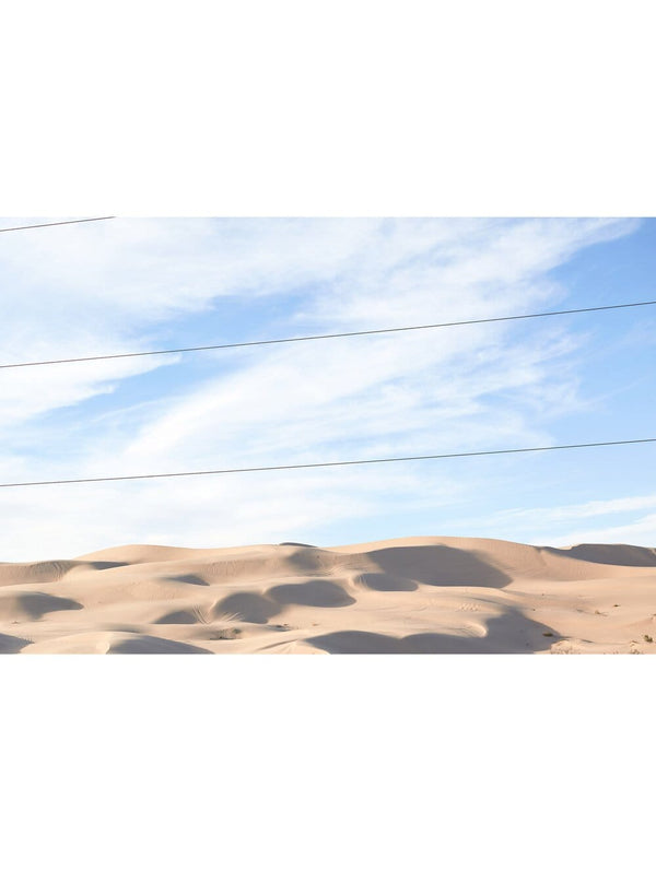 Landscape photography print of the Arizona Desert with blue sky, golden sand dunes that appear to go on for days. Perfect for people who like Joshua Tree, Palm Springs, Los Angeles, Beach and Coastal Print Artworks and Wall Décor/ Decor. This print option has no border (is full bleed) so the print goes all the way to the edge when framed.