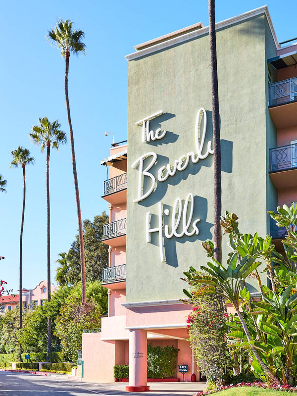 This portrait photography print was taken of The Beverly Hills Hotel in California, Los Angeles and is the perfect wall art photography print to adorn your walls and transform your home, work from home (WFH), office or business space. It features a portrait orientation shot of the Beverly Hills Hotel on a clear, sunny day, framed with tropical palm trees giving it a Miami feel. This portrait print option has no border (is full bleed) so the print goes all the way to the edge when framed.